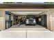 Organized two car garage with a utility sink, vehicle, trailer, and various tools and shelving at 1385 Northcliff Trce, Roswell, GA 30076