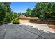 Attached two car garage with an extended driveway and lush foliage at 1385 Northcliff Trce, Roswell, GA 30076