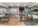 Home gym with wood floors, mirrors, gray walls, and exercise equipment including a treadmill at 1385 Northcliff Trce, Roswell, GA 30076