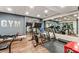 Home gym with wood floors, mirrors, gray walls, and exercise equipment including a treadmill at 1385 Northcliff Trce, Roswell, GA 30076