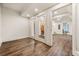 Hallway with hardwood flooring and white trim and doors to a gym, sauna, and other rooms at 1385 Northcliff Trce, Roswell, GA 30076