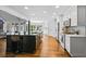 Modern kitchen features an island, white cabinets, stainless steel appliances, and hardwood floors at 1385 Northcliff Trce, Roswell, GA 30076