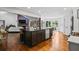 An open concept kitchen featuring an island and stainless steel appliances, flowing into the living area at 1385 Northcliff Trce, Roswell, GA 30076