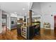 Kitchen island with bar stools and stainless steel appliances, with an open view to the dining area at 1385 Northcliff Trce, Roswell, GA 30076