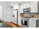 Modern kitchen with stainless steel appliances, white cabinets, and tiled backsplash at 1385 Northcliff Trce, Roswell, GA 30076
