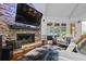 Living room featuring a stone fireplace and large windows, creating a bright and inviting space at 1385 Northcliff Trce, Roswell, GA 30076