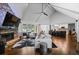 Spacious living room featuring a stone fireplace, high ceilings, and an open concept design with hardwood floors at 1385 Northcliff Trce, Roswell, GA 30076