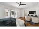 Spacious main bedroom with hardwood floors, TV, and access to an outdoor deck at 1385 Northcliff Trce, Roswell, GA 30076