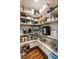 Well-organized walk-in pantry with ample shelving for storage at 1385 Northcliff Trce, Roswell, GA 30076
