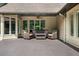 Covered patio with wicker furniture set and ceiling fan at 1385 Northcliff Trce, Roswell, GA 30076