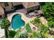 An aerial view of the pool with its stone design and lush tropical landscaping, perfect for relaxation at 1385 Northcliff Trce, Roswell, GA 30076