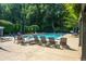 A community pool surrounded by lounge chairs and umbrellas provides a resort-style amenity at 1385 Northcliff Trce, Roswell, GA 30076