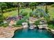 A beautiful pool features rock features, manicured landscaping, and a small waterfall at 1385 Northcliff Trce, Roswell, GA 30076