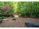 An outdoor storage shed sits at the edge of the backyard amongst trees at 1385 Northcliff Trce, Roswell, GA 30076