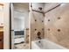 Elegant shower and tub combination featuring decorative tile and a view into an adjacent bedroom at 1385 Northcliff Trce, Roswell, GA 30076