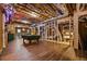 Unfinished basement with exposed ducts, wood flooring and a pool table and storage space at 1385 Northcliff Trce, Roswell, GA 30076