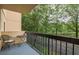 Relaxing outdoor balcony with black metal railing and chair overlooking a scenic treed view at 1800 Clairmont Lk # A226, Decatur, GA 30033