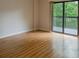 Bright bedroom with hardwood floors and sliding glass doors leading to a balcony at 1800 Clairmont Lk # A226, Decatur, GA 30033