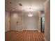Open living room area with light wood floors and neutral paint, featuring a modern light fixture at 1800 Clairmont Lk # A226, Decatur, GA 30033