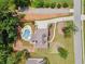 Overhead aerial shot of the home, pool, driveway, manicured landscaping, and street at 212 Wilshire Ter, White, GA 30184
