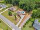 Aerial view of a home with a private pool, lush landscaping, and a long driveway at 212 Wilshire Ter, White, GA 30184