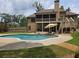 Backyard view of home featuring pool, screened porch, and multi-level deck at 212 Wilshire Ter, White, GA 30184