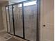 Stylish bathroom featuring frameless glass shower, gray tiling, and a recessed shower niche at 212 Wilshire Ter, White, GA 30184