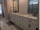 Bathroom features a double sink vanity with white cabinetry and stone countertops at 212 Wilshire Ter, White, GA 30184