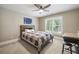 Bedroom featuring a ceiling fan, a window, a bed, and a desk with a stool at 212 Wilshire Ter, White, GA 30184