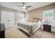 Cozy bedroom with neutral walls and a comfortable bed dressed with patterned pillows and bedspread at 212 Wilshire Ter, White, GA 30184