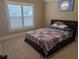 Comfortable bedroom with a dark bed frame, neutral paint, and bright shuttered windows at 212 Wilshire Ter, White, GA 30184