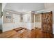 Welcoming entryway featuring hardwood floors, white trim, a barn door, and neutral wall paint at 212 Wilshire Ter, White, GA 30184