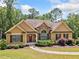 Charming one-story home with stone accents, manicured landscaping, and a welcoming walkway at 212 Wilshire Ter, White, GA 30184