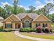 Charming one-story home with stone accents, manicured landscaping, and a welcoming walkway at 212 Wilshire Ter, White, GA 30184