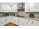 Well-appointed kitchen features white cabinetry, stainless steel appliances, and granite countertops at 212 Wilshire Ter, White, GA 30184