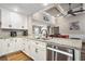 Modern kitchen with white cabinets, stainless steel appliances, granite countertops, and open to the living area at 212 Wilshire Ter, White, GA 30184