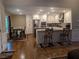 Bright, open kitchen with an island, stainless steel appliances, and a view into the dining area at 212 Wilshire Ter, White, GA 30184
