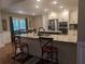 Open kitchen layout with stainless steel appliances, granite counters and a breakfast bar at 212 Wilshire Ter, White, GA 30184