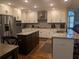 Modern kitchen features granite countertops, stainless steel appliances, and ample cabinet space at 212 Wilshire Ter, White, GA 30184