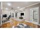 Living room with ceiling fan, TV, french doors to exercise room, and access to shower at 212 Wilshire Ter, White, GA 30184