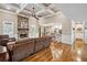 Open-concept living room featuring a stone fireplace, hardwood floors, and flows into a stylish kitchen area at 212 Wilshire Ter, White, GA 30184