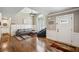 Bright living room featuring hardwood floors, a modern sectional, and a tall arched window at 212 Wilshire Ter, White, GA 30184