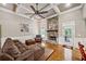 Inviting living room with stone fireplace, hardwood floors, and access to an outdoor patio area at 212 Wilshire Ter, White, GA 30184