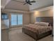 Tranquil main bedroom offers tray ceilings, neutral colors, and an abundance of natural light at 212 Wilshire Ter, White, GA 30184