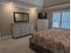 The main bedroom has a large dresser, flatscreen television, and shuttered windows at 212 Wilshire Ter, White, GA 30184