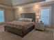 Serene main bedroom retreat with a large window, tray ceiling, and a cozy atmosphere at 212 Wilshire Ter, White, GA 30184