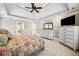 Bright main bedroom with tray ceiling, ceiling fan, neutral walls, and carpet at 212 Wilshire Ter, White, GA 30184