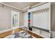 A stylish mudroom features a white coat rack with a bench and colorful storage bins plus an adjacent bathroom at 212 Wilshire Ter, White, GA 30184