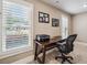 Office space with a desk and a chair next to windows with plantation shutters at 212 Wilshire Ter, White, GA 30184