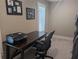 Cozy office space with a wooden desk, comfortable chair, and natural light from shuttered windows at 212 Wilshire Ter, White, GA 30184